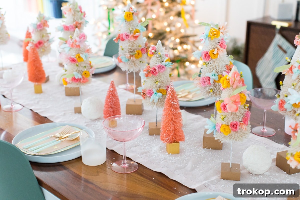 Charming DIY Floral Bottle Brush Christmas Table Decor 5 A complete holiday tablescape showcasing faux flower bottle brush trees as the stunning centerpiece, surrounded by plates and candles.