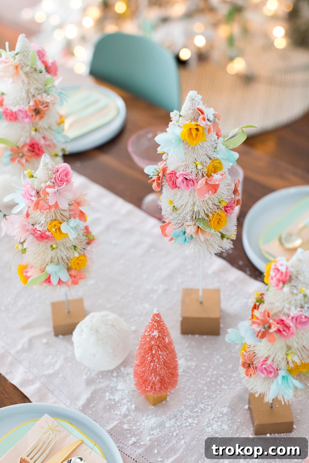Charming DIY Floral Bottle Brush Christmas Table Decor 6 Gorgeous faux flower bottle brush trees on display, highlighting their charming and unique festive appearance.