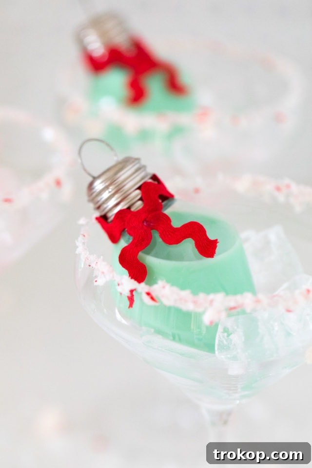 Homemade Holiday Cocktail Baubles 2 Mint green Christmas cocktail ornament hanging from a tree, ready to be enjoyed.
