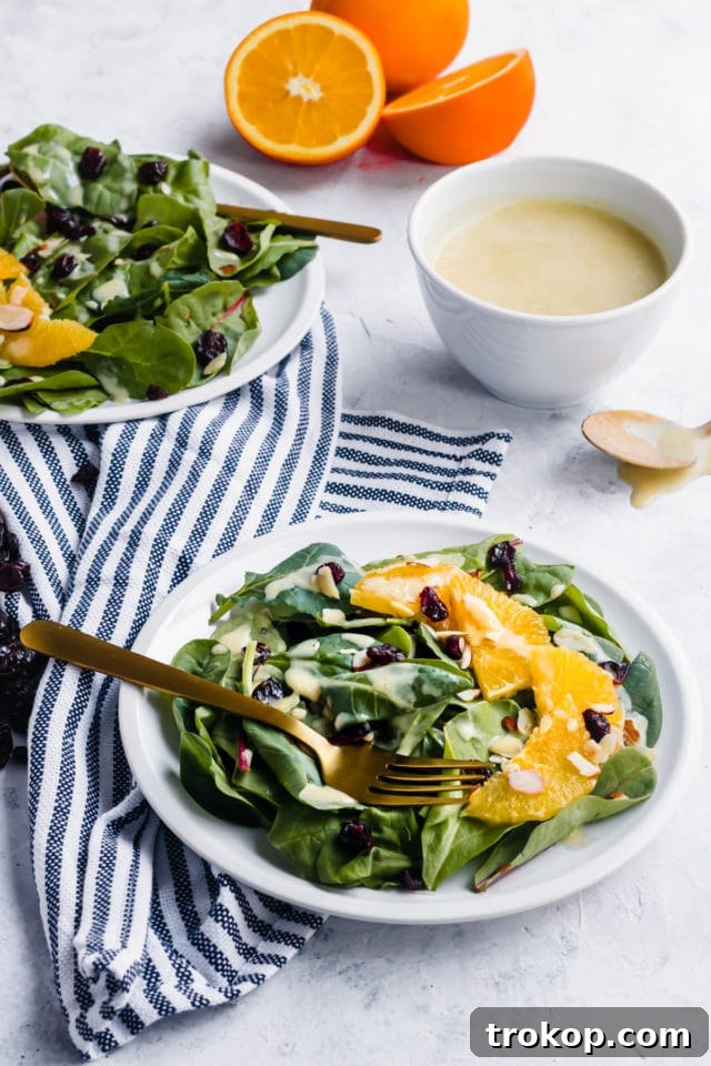 Vibrant Cranberry Orange Salad with Luscious Citrus Vinaigrette 4 Fresh ingredients laid out for Cranberry Orange Salad preparation, including oranges and greens.