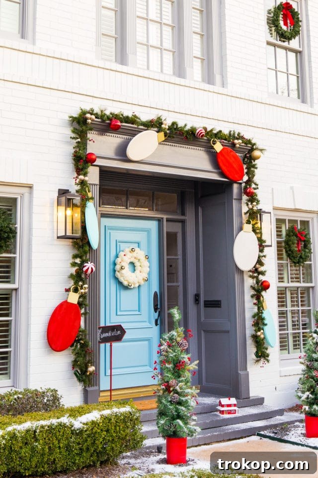 Overview of a festive front door with a jumbo light bulb garland