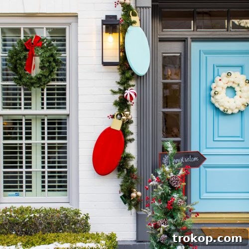 Photo of a house with Christmas wreaths and garland for front door decorations