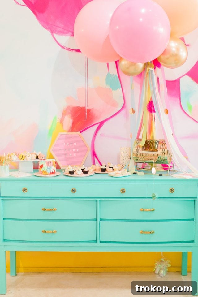 First birthday party food and decor ideas by Sugar & Cloth, showcasing a colorful table setting