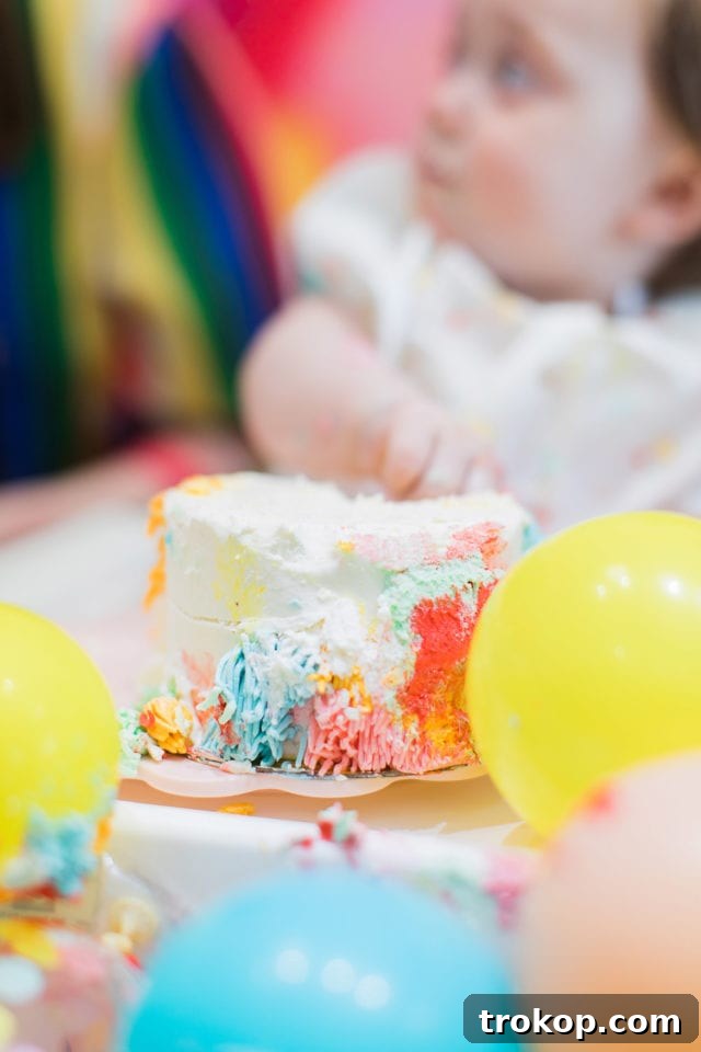 Gwen trying her birthday cake for the first time, a classic smash cake moment