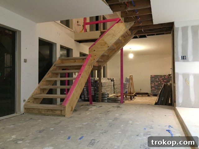 A detailed view of the new floating staircase installation, showcasing the individual ash wood treads and the open design.