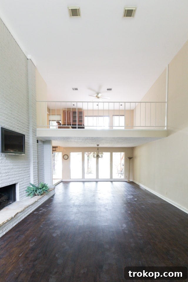 A 'before' view of the old, dated upstairs balcony and railing, highlighting the need for modernization and improved safety for the renovation project.
