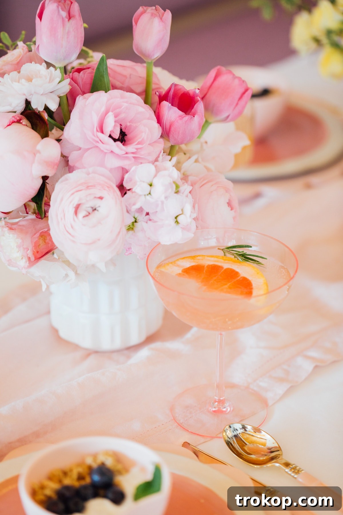 Refreshing brunch cocktails in pastel pink coupes on a beautiful table
