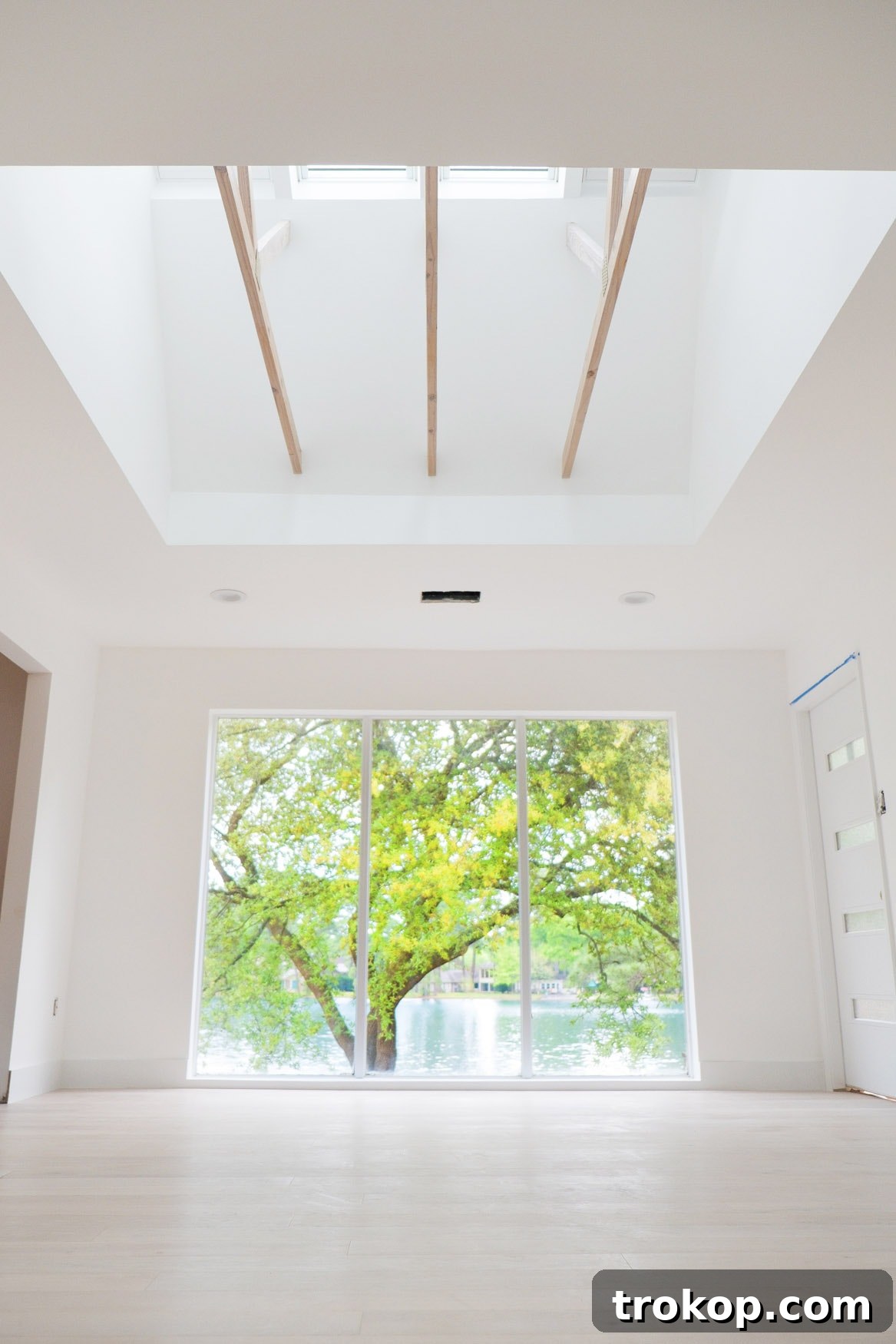 New Home New Light Our Skylight Transformation 9 After: An upward angle on our new master bedroom with Velux skylights, showcasing the bright, open feel and the beautifully finished whitewashed beams. The gold-painted brackets add a custom touch, blending modern design with structural elements.