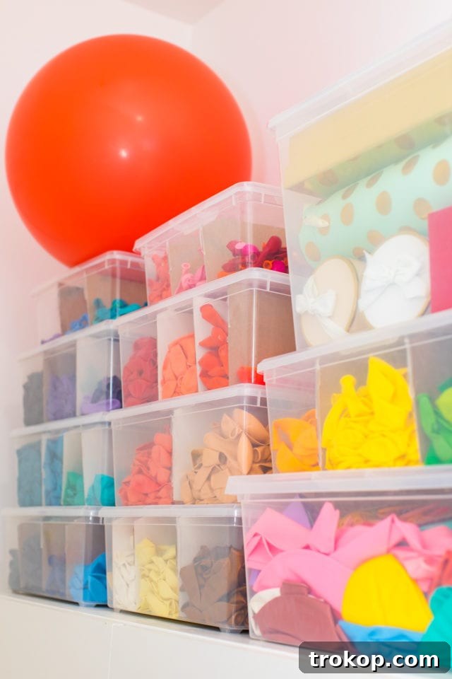 Unveiling My New Studio and Craft Nook 11 Close-up of balloon organization in clear bins with cardboard dividers, showcasing a smart DIY solution for color-coding craft supplies in the studio.