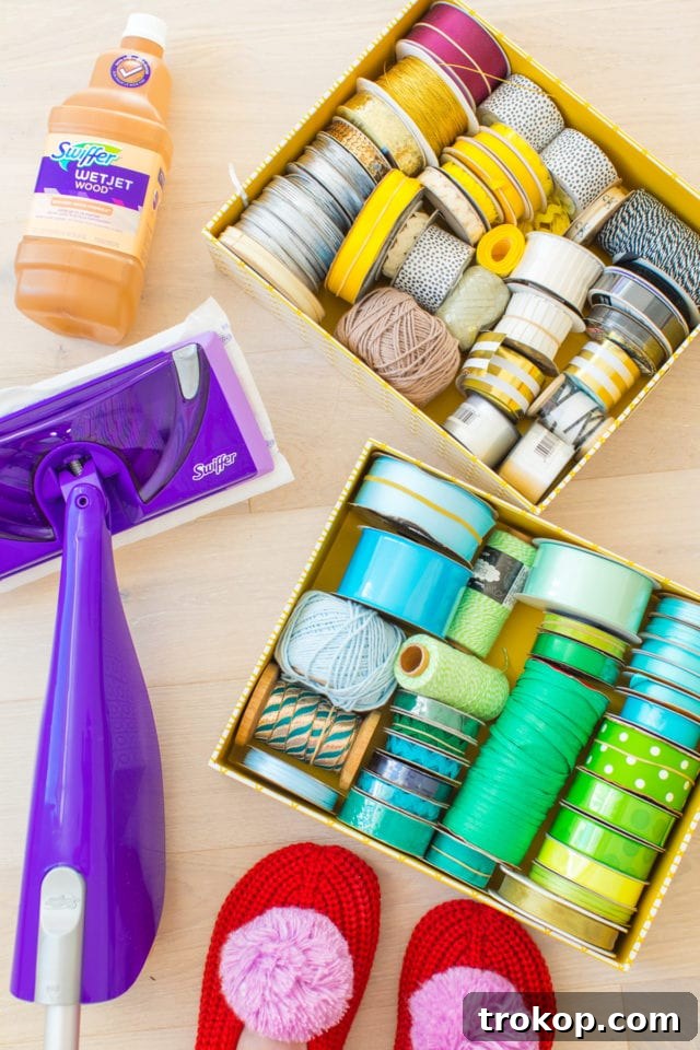 Unveiling My New Studio and Craft Nook 12 Detailed view of ribbon and twine organized by color in cardboard storage boxes within the craft closet, demonstrating effective craft storage ideas.