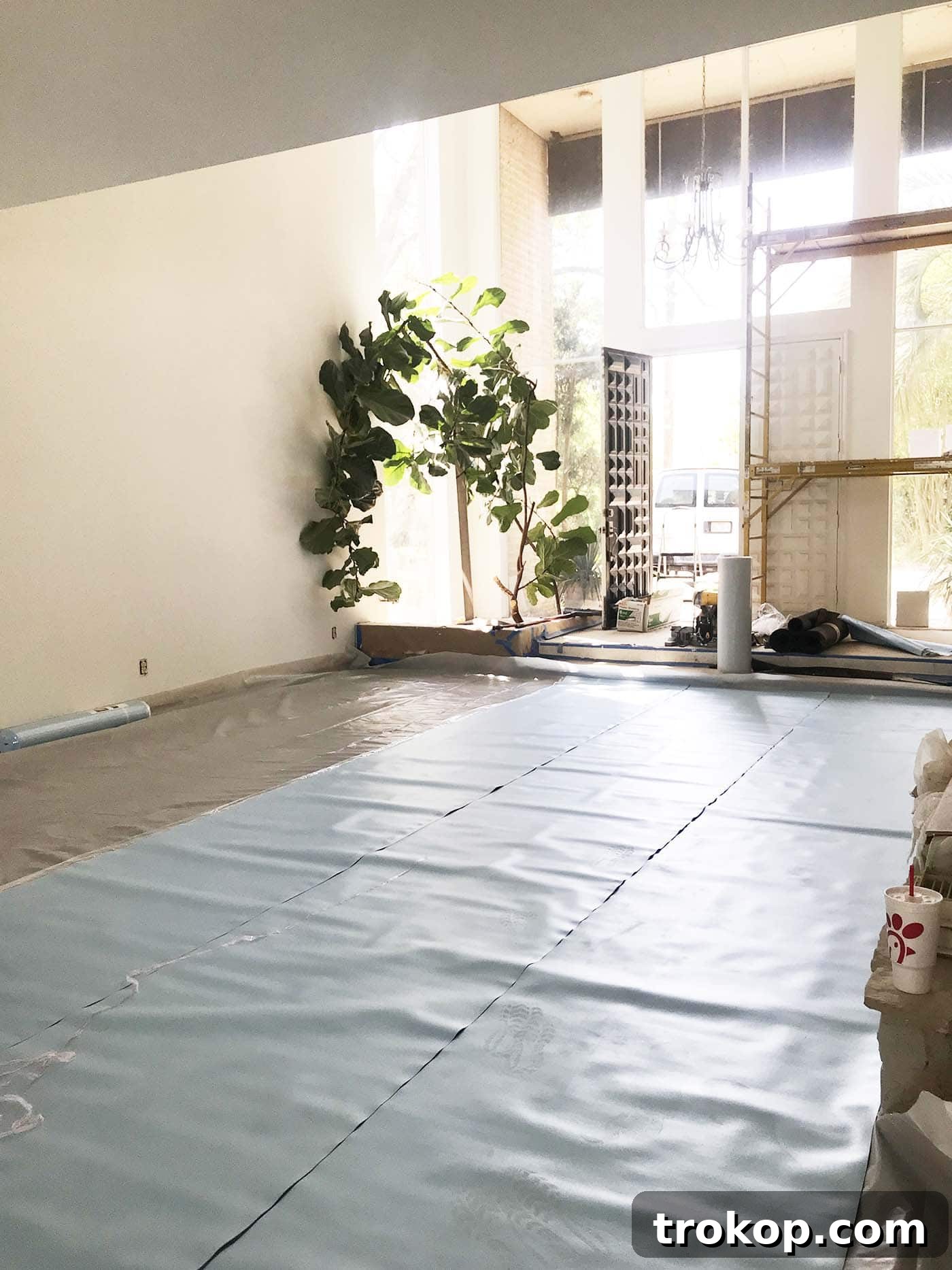 Living room renovation progress showcasing stripped floors and exposed foundation issues during One Room Challenge Week 4 by Sugar & Cloth