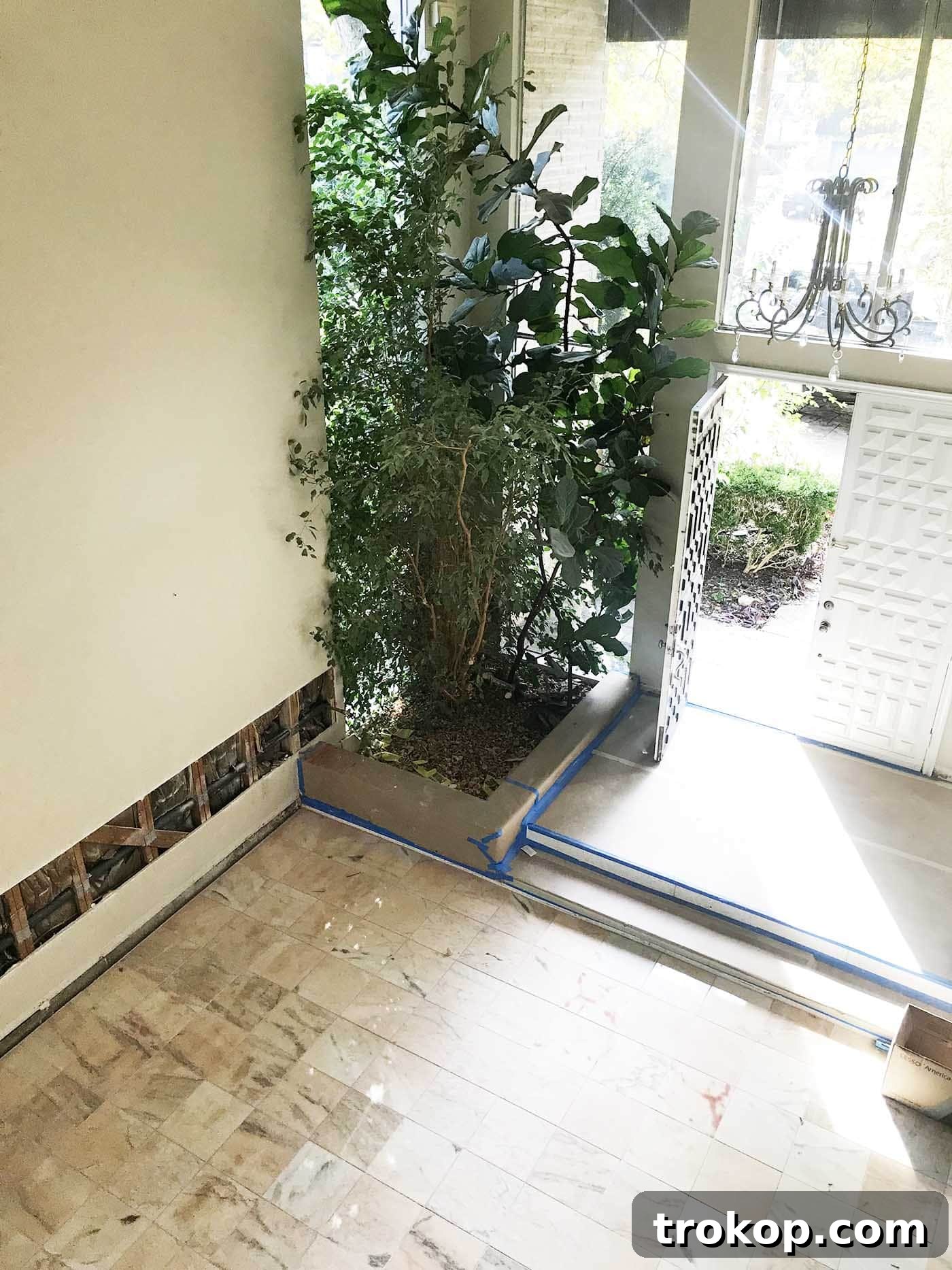One Room Challenge Week 4 Living Room Renovation Hits a Costly Construction Snag 5 Exterior inspection of house revealing previously blocked foundation weep holes and inadequate yard drainage, a common renovation hurdle