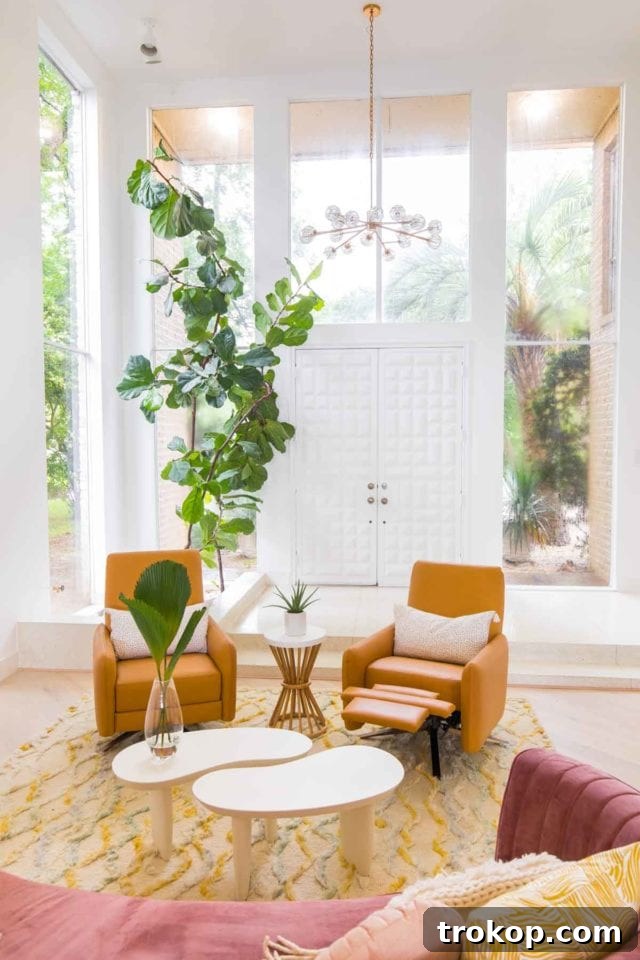 View of the dining room featuring a modern white extendable table, elegant Tia Y chairs, and a striking Hudson Valley Lighting pendant, ideal for entertaining.