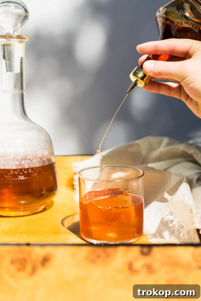 A close-up of the ingredients laid out for a Coffee Old Fashioned cocktail, including bourbon and coffee liqueur.