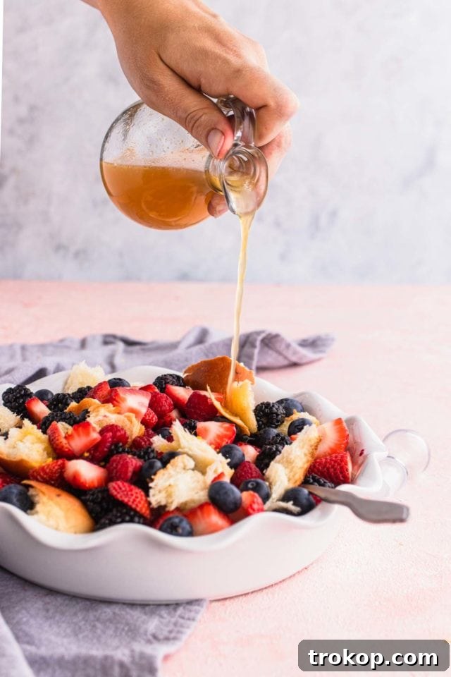Sweet & Savory Berry Panzanella 5 Close-up shot of the Berry Panzanella Salad dressing being poured over the berries and bread, highlighting its smooth texture.