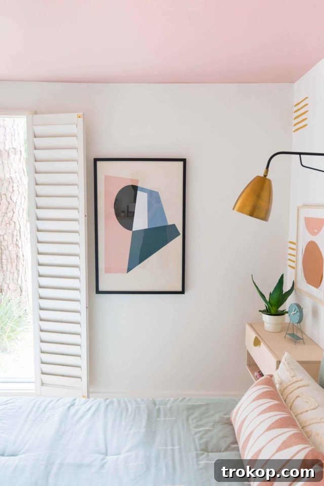 Detailed view of the guest bedroom's accent wall pattern and stylish bedside decor.