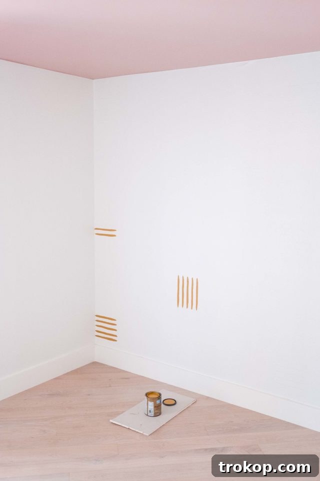 Measuring and marking the accent wall pattern with a pencil.
