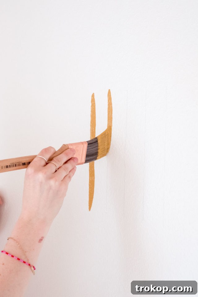 Marking the entire accent wall pattern with a pencil before painting.