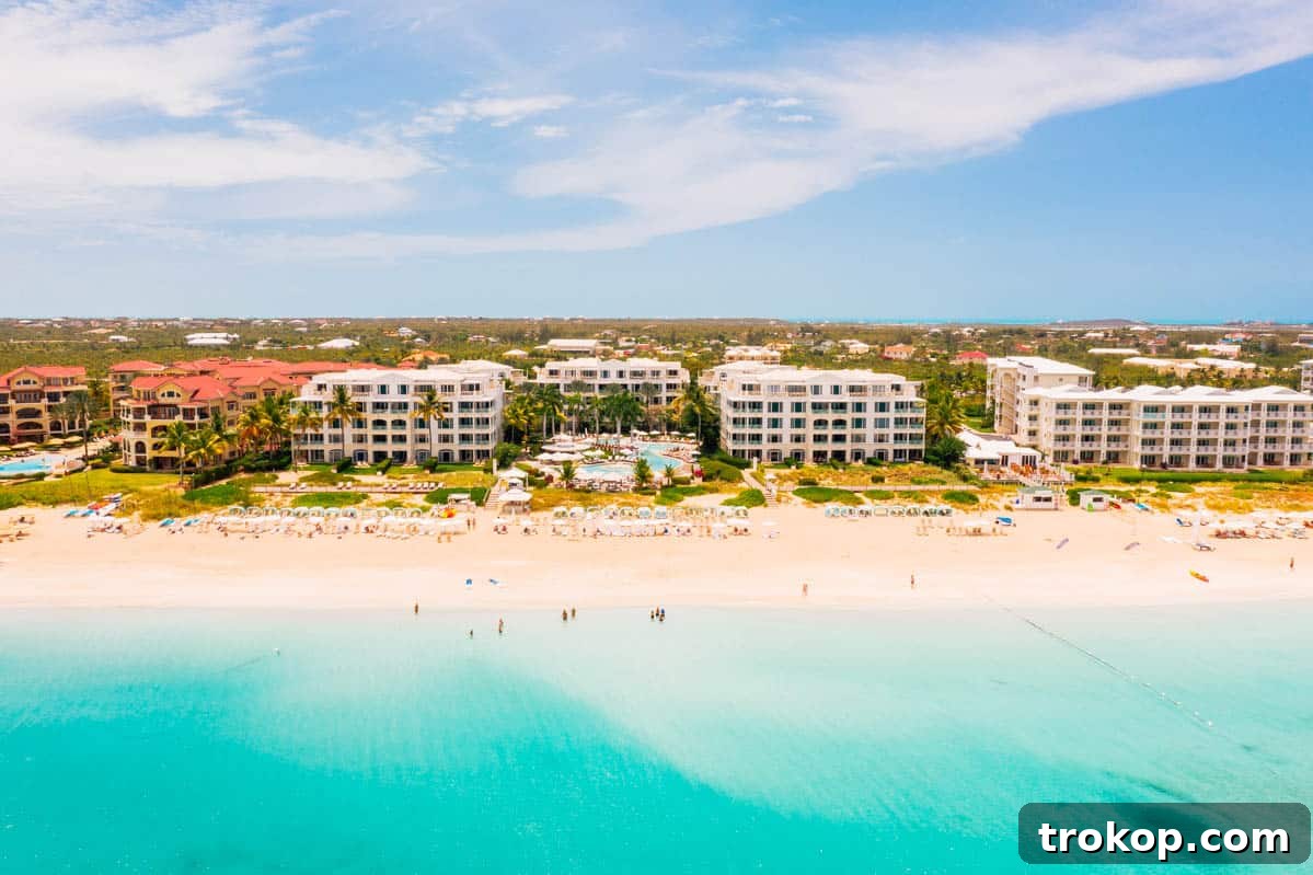 Ultimate Family Getaway: Beaches Turks and Caicos All-Inclusive Adventure 4 Family relaxing on the pristine white sands of Grace Bay, Turks & Caicos.