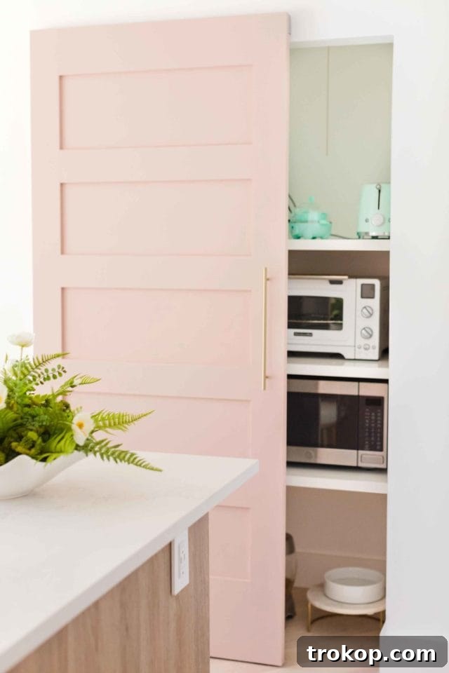 Modern kitchen with GE Cafe double wall oven and bronze hardware