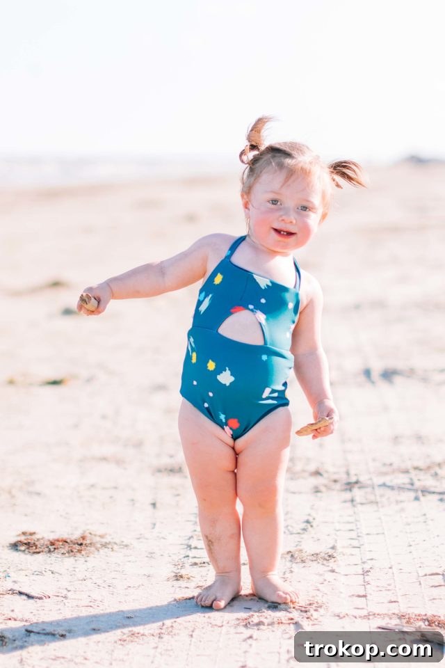 Full back view of Gwen in the Malibu one-piece swimsuit, highlighting the cute tie details and confetti print of the Sugar & Cloth x Olivia + Ocean design.