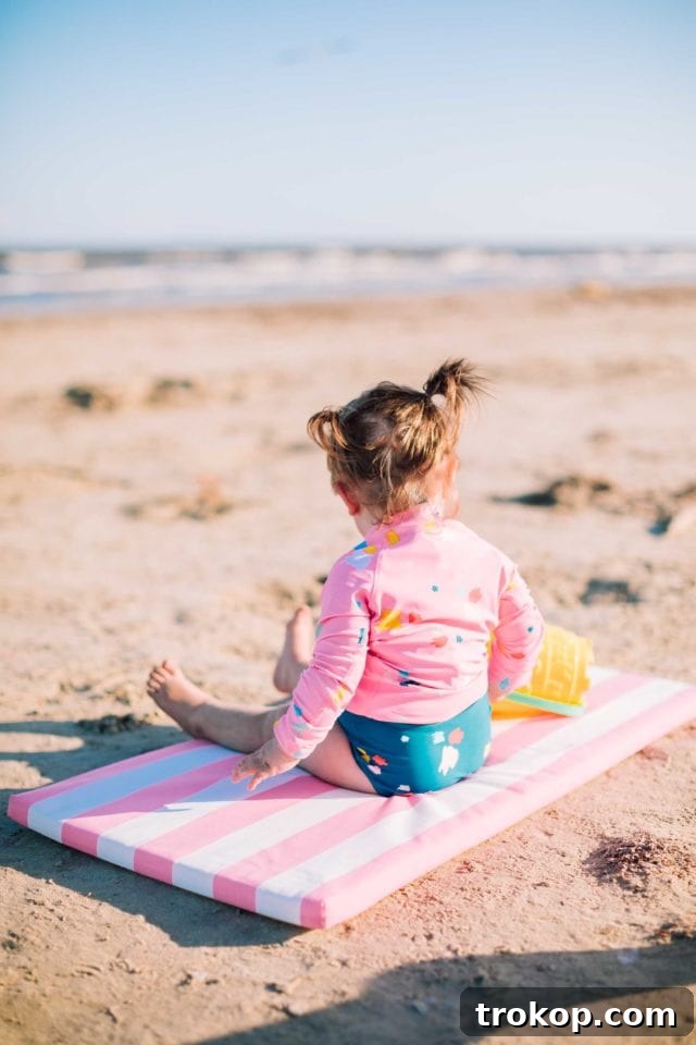 Full back view of Ashley Rose in the striped mom bod one-piece swimsuit, showing the flattering cut and quality fabric of the Olivia + Ocean design.