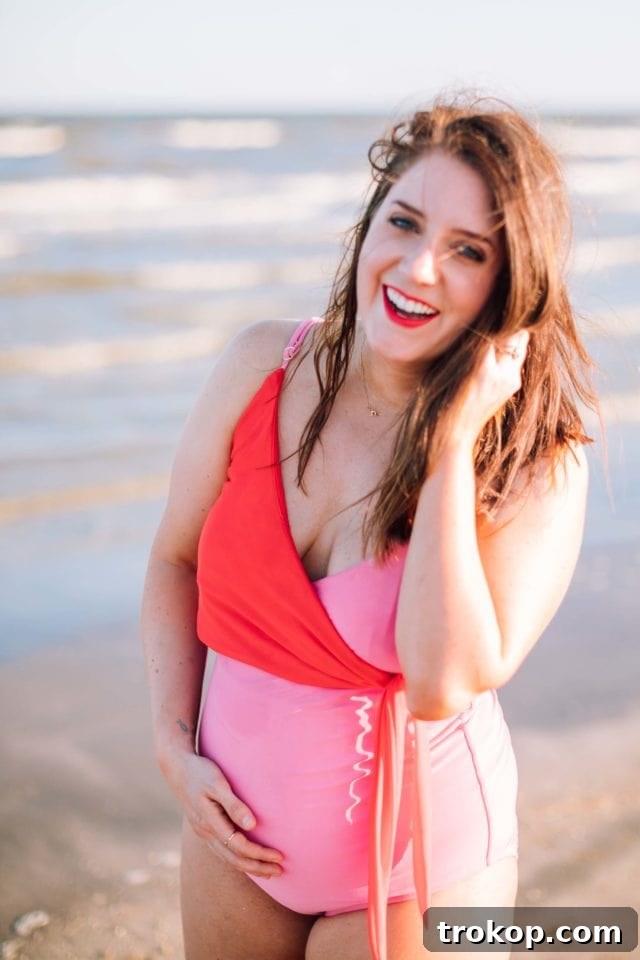 Ashley Rose smiling while posing in the color block mom bod one-piece, showcasing the confidence and style delivered by the Sugar & Cloth x Olivia + Ocean collection.