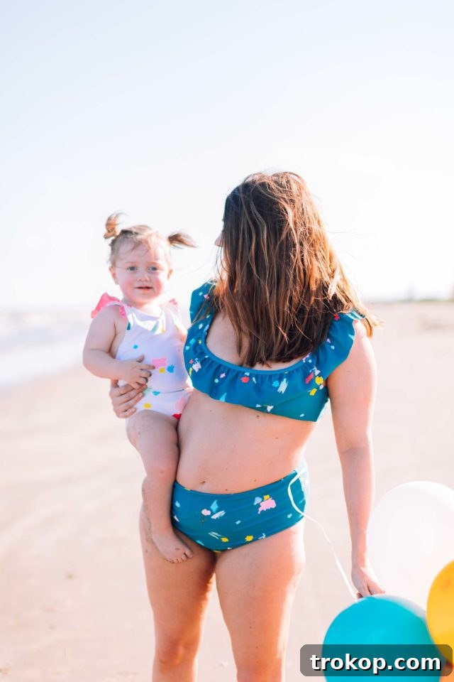Close-up of the ruffled detail on the confetti print girls' one-piece swimsuit, highlighting the quality and charming design elements of the Sugar & Cloth x Olivia + Ocean collection.