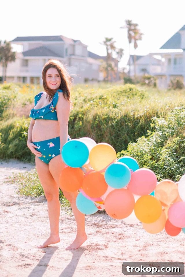 Ashley Rose of Sugar & Cloth wearing the confetti print ruffled bikini top and bottom, showcasing the stylish and supportive design of the Olivia + Ocean collaboration.