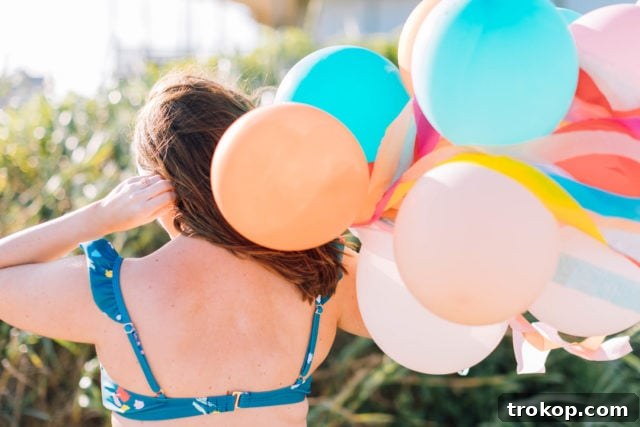 Ashley Rose of Sugar & Cloth posing in the confetti print bikini top, highlighting the comfort and style of her design for the Olivia + Ocean collaboration.