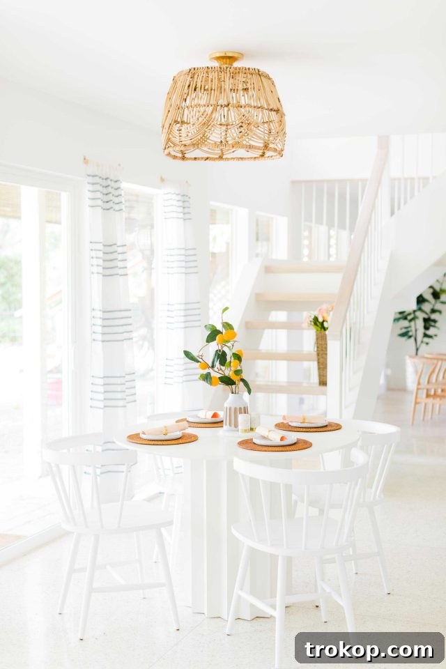 Woven Basket Pendant Light 2 A stunning DIY basket pendant light fixture hanging above a breakfast nook table.