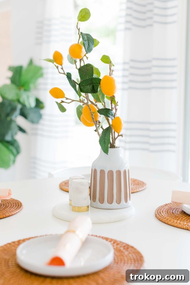 Woven Basket Pendant Light 5 Styled breakfast nook table with a lemon plant centerpiece, woven placemats, and the DIY basket pendant light overhead.
