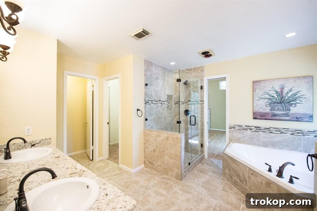 Before photo of an old, dated shower in a master bathroom, featuring worn tiles and fixtures, awaiting a modern and luxurious remodel by Sugar & Cloth.