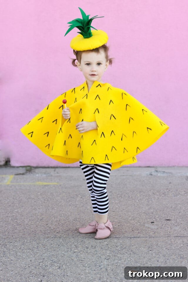 Child wearing a charming DIY Pineapple Cape Halloween costume made from felt