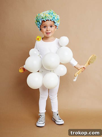 Child in a creative DIY Bubble Bath Halloween costume with white balloons