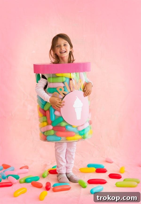 Child in a vibrant DIY Jar of Sprinkles Halloween costume with colorful balloons