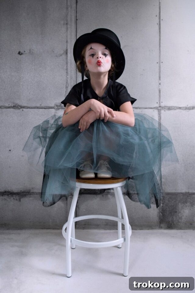 Child dressed in a colorful and whimsical Harlequin Clown DIY Halloween costume