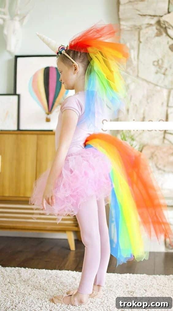 Child in a magical DIY Rainbow Unicorn Halloween costume with a colorful mane and horn