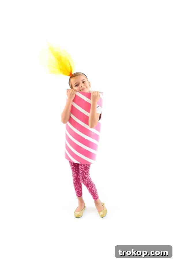Child dressed in a colorful DIY Birthday Candle Halloween costume with a flame hat