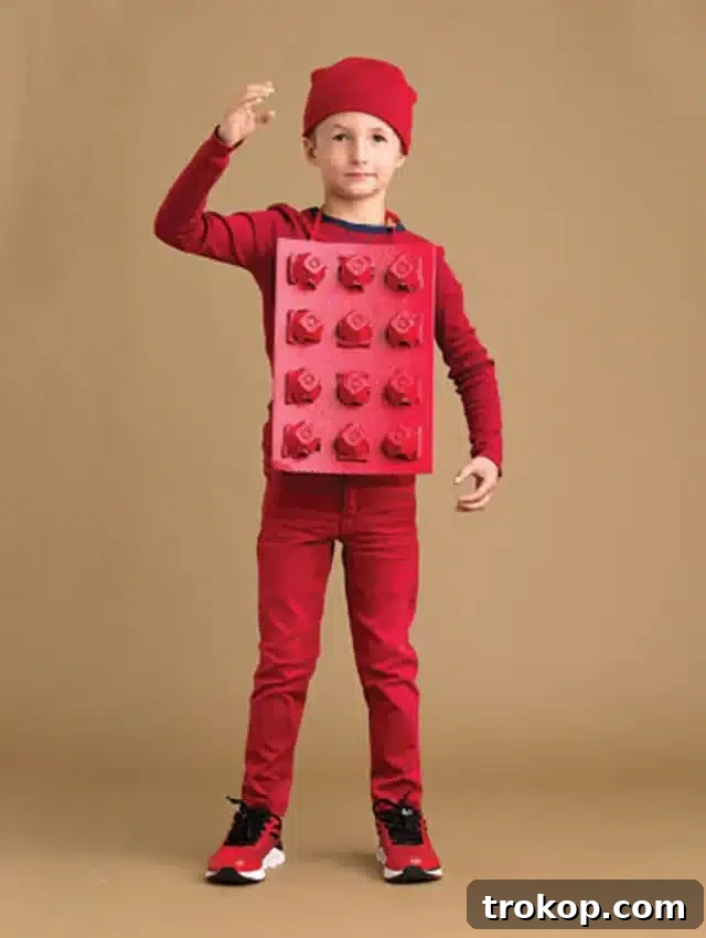 Child wearing a vibrant DIY Lego block Halloween costume made from cardboard