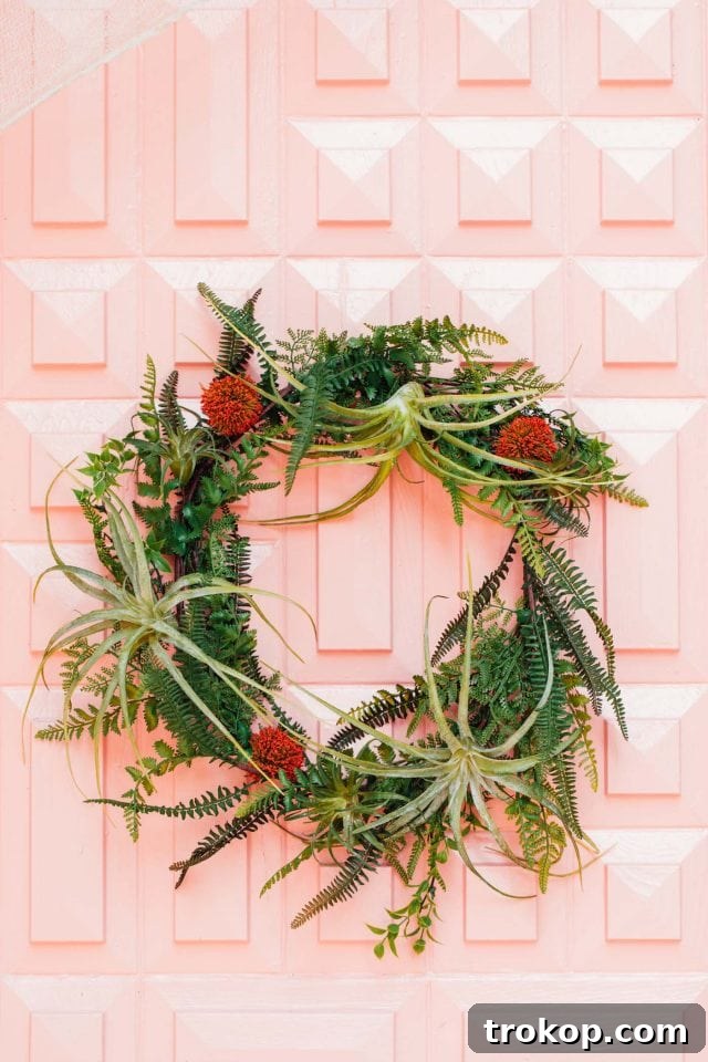 Whimsical Halloween Door Decorating Ideas 4 An outdoor Halloween wreath featuring green fern and elegant accents