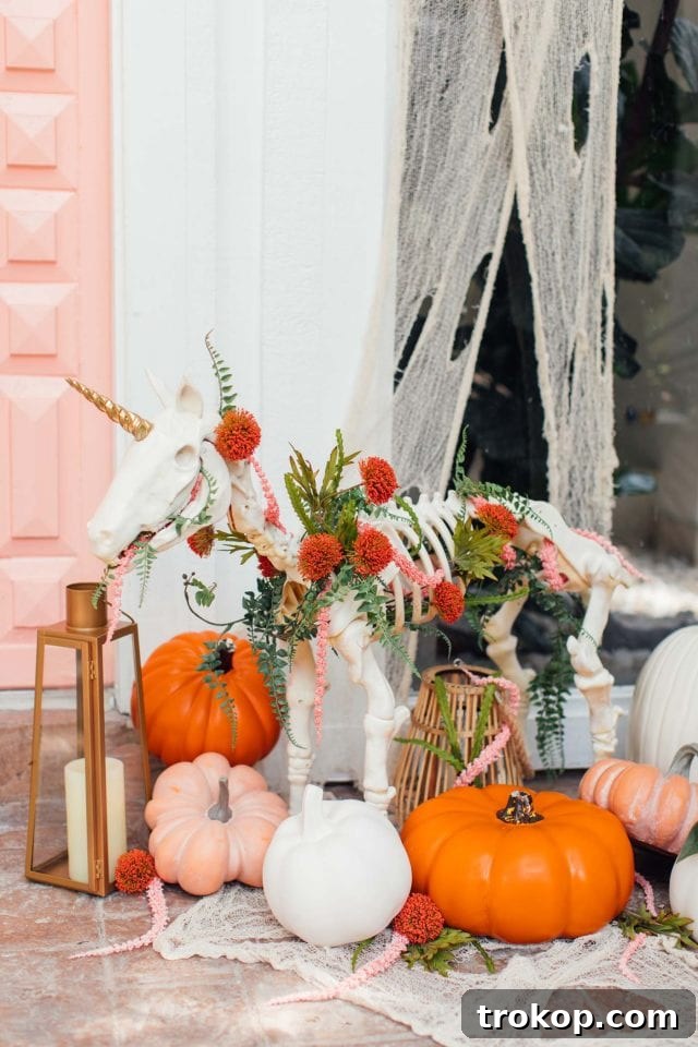 Whimsical Halloween Door Decorating Ideas 8 A charming pink door decorated for Halloween with a unique unicorn skeleton and festive elements