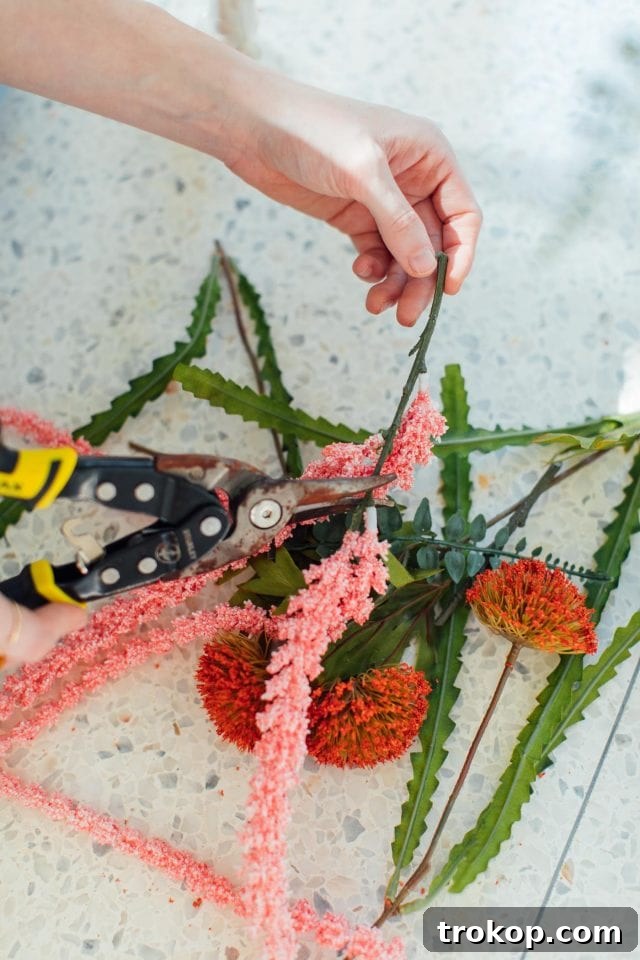 Whimsical Halloween Door Decorating Ideas 9 A person cutting faux flowers to decorate a unicorn skeleton for Halloween