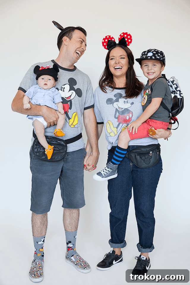 40 Spooktacular Family Halloween Costume Ideas 12 A family comically dressed as Disneyland tourists for Halloween, complete with fanny packs, matching shirts, and cameras.