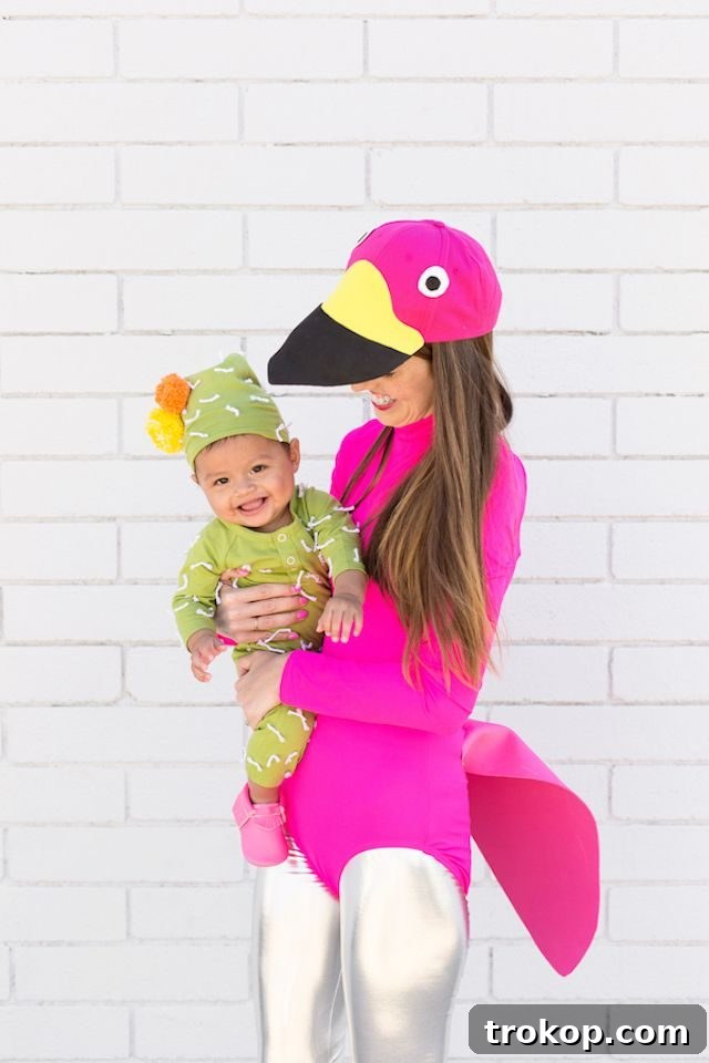 40 Spooktacular Family Halloween Costume Ideas 13 A mother dressed as a vibrant lawn flamingo and her baby as an adorable cactus, a Palm Springs inspired Mommy and Me Halloween costume.