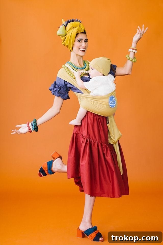 40 Spooktacular Family Halloween Costume Ideas 15 A mother dressed as a vibrant Chiquita Banana, with her baby bundled sweetly in a DIY banana wrap costume.