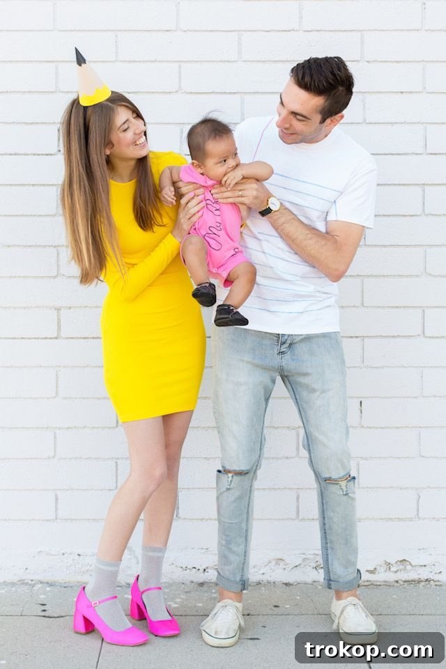 40 Spooktacular Family Halloween Costume Ideas 18 A family wearing creative DIY school supply themed costumes for Halloween, featuring a pencil, paper, and a cute baby eraser.