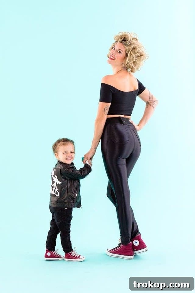 40 Spooktacular Family Halloween Costume Ideas 19 A mother and toddler dressed in iconic Grease-inspired Halloween costumes, featuring a mini Danny Zuko.