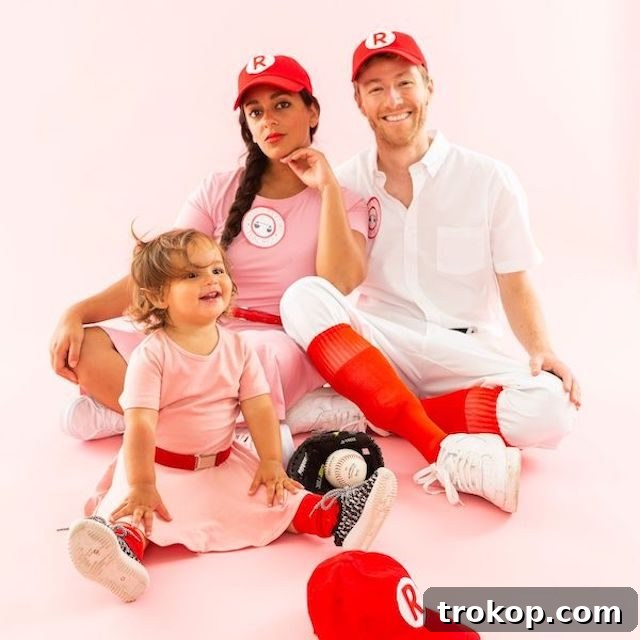 40 Spooktacular Family Halloween Costume Ideas 20 Parents and child dressed in iconic A League of Their Own baseball uniforms for a sporty and spirited family Halloween costume.