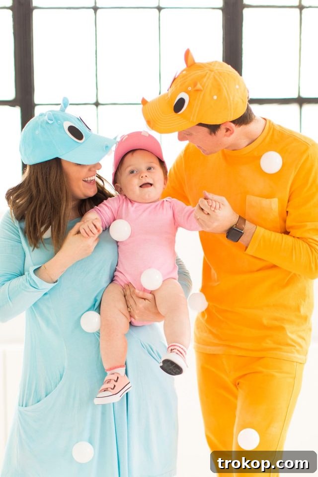40 Spooktacular Family Halloween Costume Ideas 3 A family of four dressed in a creative DIY Hungry Hippos Halloween costume, featuring a baby in a hippo outfit.